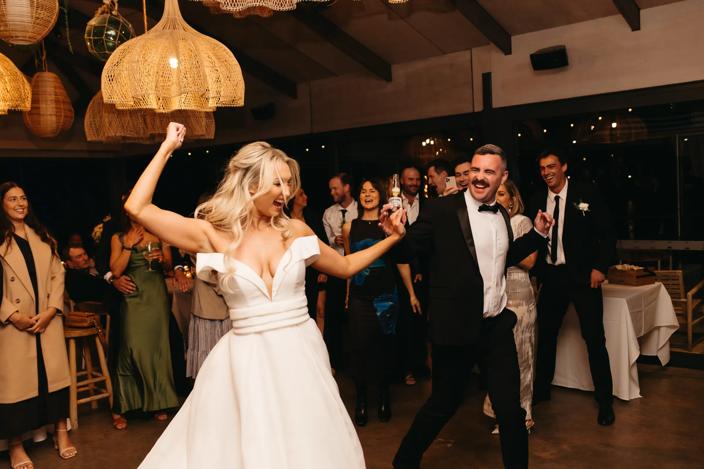 Lauren and Daniel celebrating at their Sandstone Point Hotel wedding