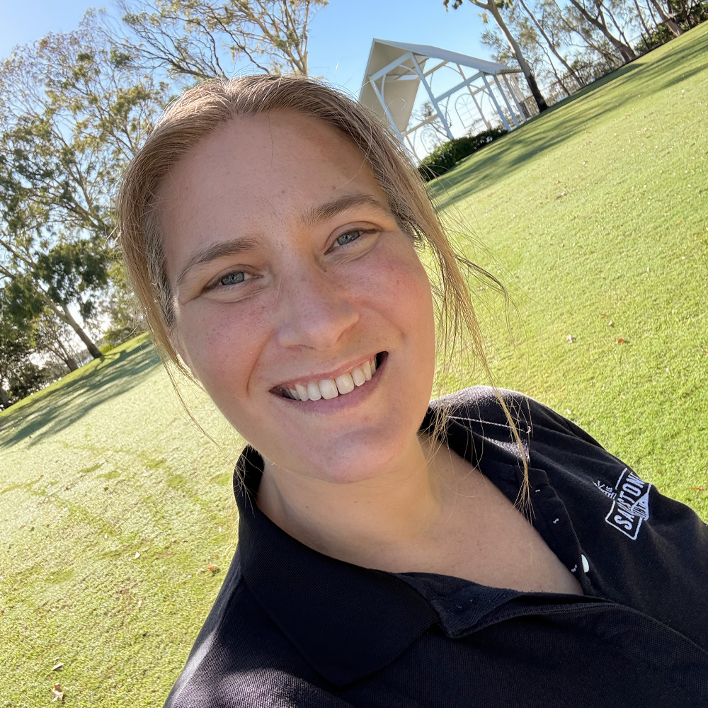 Zoe smiling outdoors at Sandstone Point Hotel
